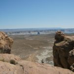 Standing above a fallen arch in the Graveyard of Fallen Arches overlooking Lake Powell, Glen Canyon National Recreation Area, Utah