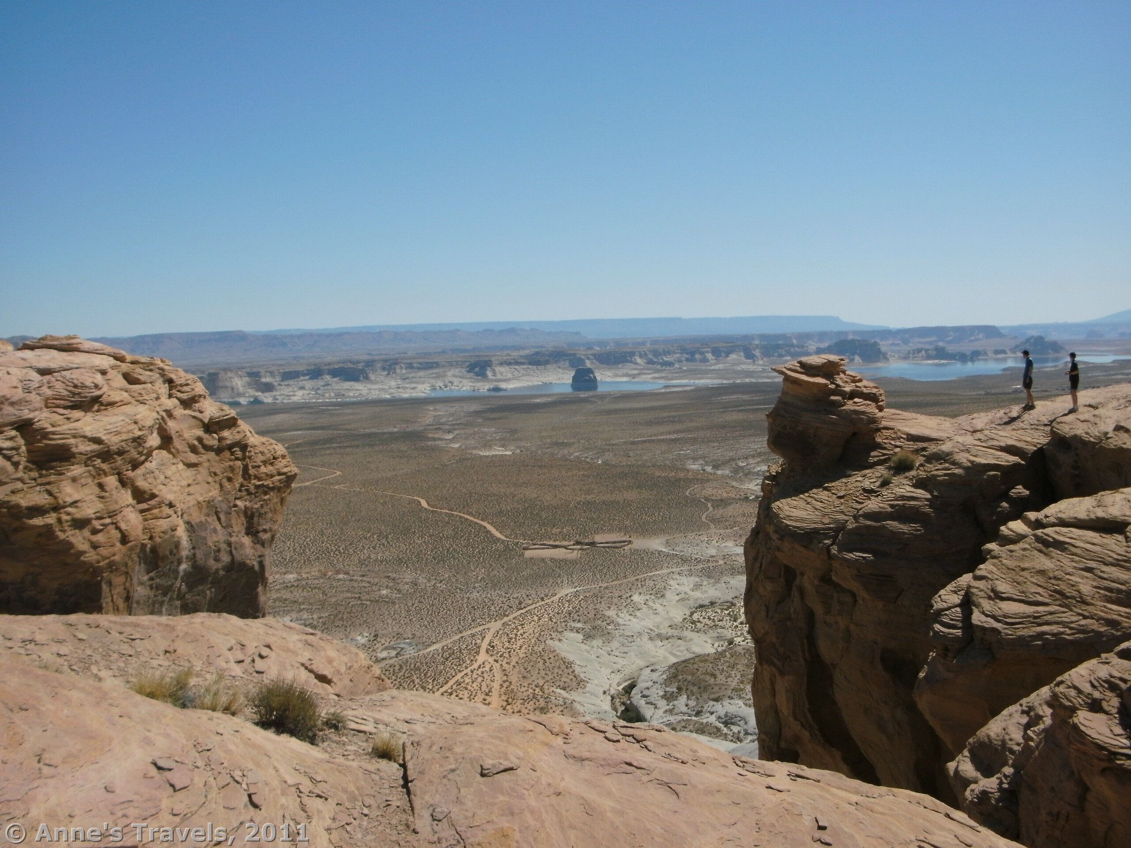 Standing above a fallen arch in the Graveyard of Fallen Arches overlooking Lake Powell, Glen Canyon National Recreation Area, Utah