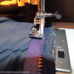 Using a sewing machine to sew a new zipper to a sleeping bag