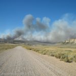 Smoke pours up from a wildfire next to I-80 in Wyoming. We're on a dirt road to the the south of the highway.