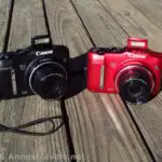 A black model and red model of the Canon PowerShot SX160 camera