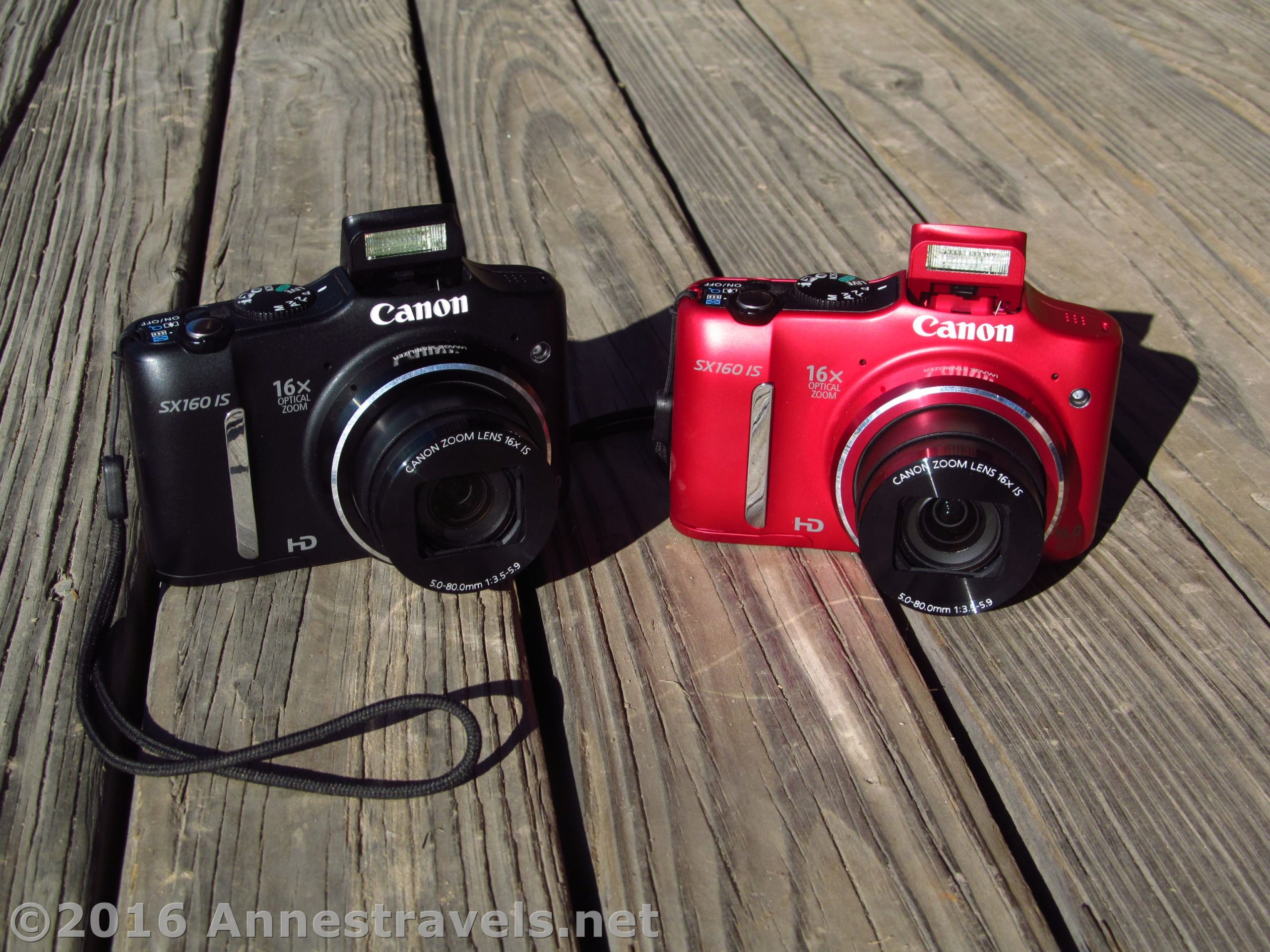 A black model and red model of the Canon PowerShot SX160 camera