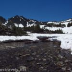 A stream frees itself of the snow in the cirque below Burro Pass above the Virginia Lakes in Humboldt-Toiyabe National Forest, California