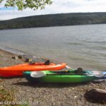 A Lifetime Lancer 100 Kayak and L.L. Bean Manatee 100 Kayak on the shore of the lake