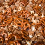 Caramel Corn Snack Mix with pretzels, popcorn, peanuts, Chex, and a sweet, sticky glaze