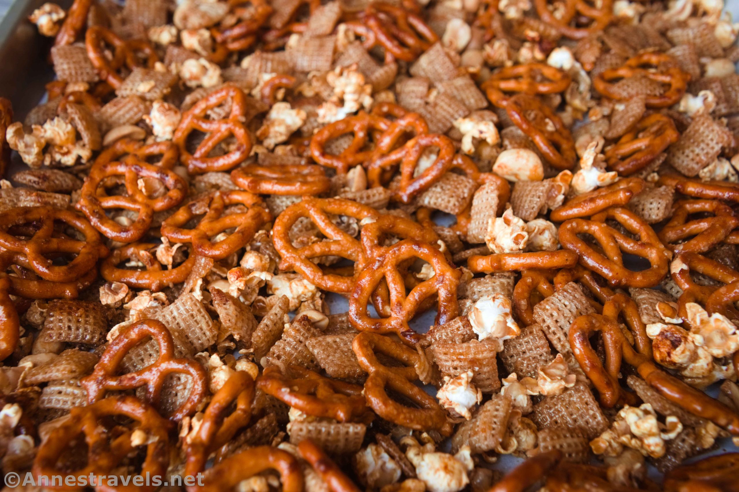 Caramel Corn Snack Mix with pretzels, popcorn, peanuts, Chex, and a sweet, sticky glaze