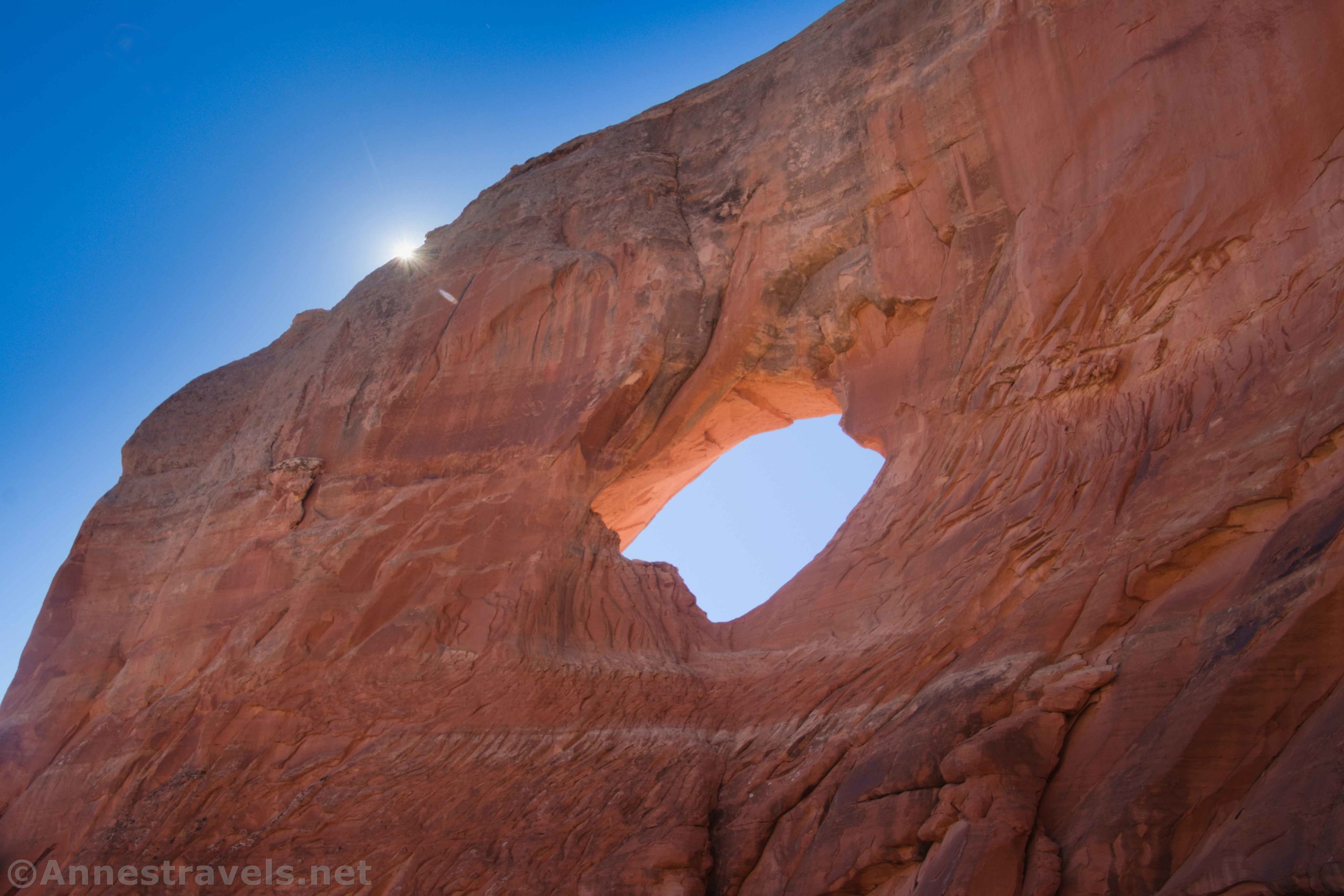 A sun star above Squaw Window, Moab, Utah