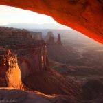 Views of rock formations through Mesa Arch near sunrise, Island in the Sky District, Canyonlands National Park, Utah