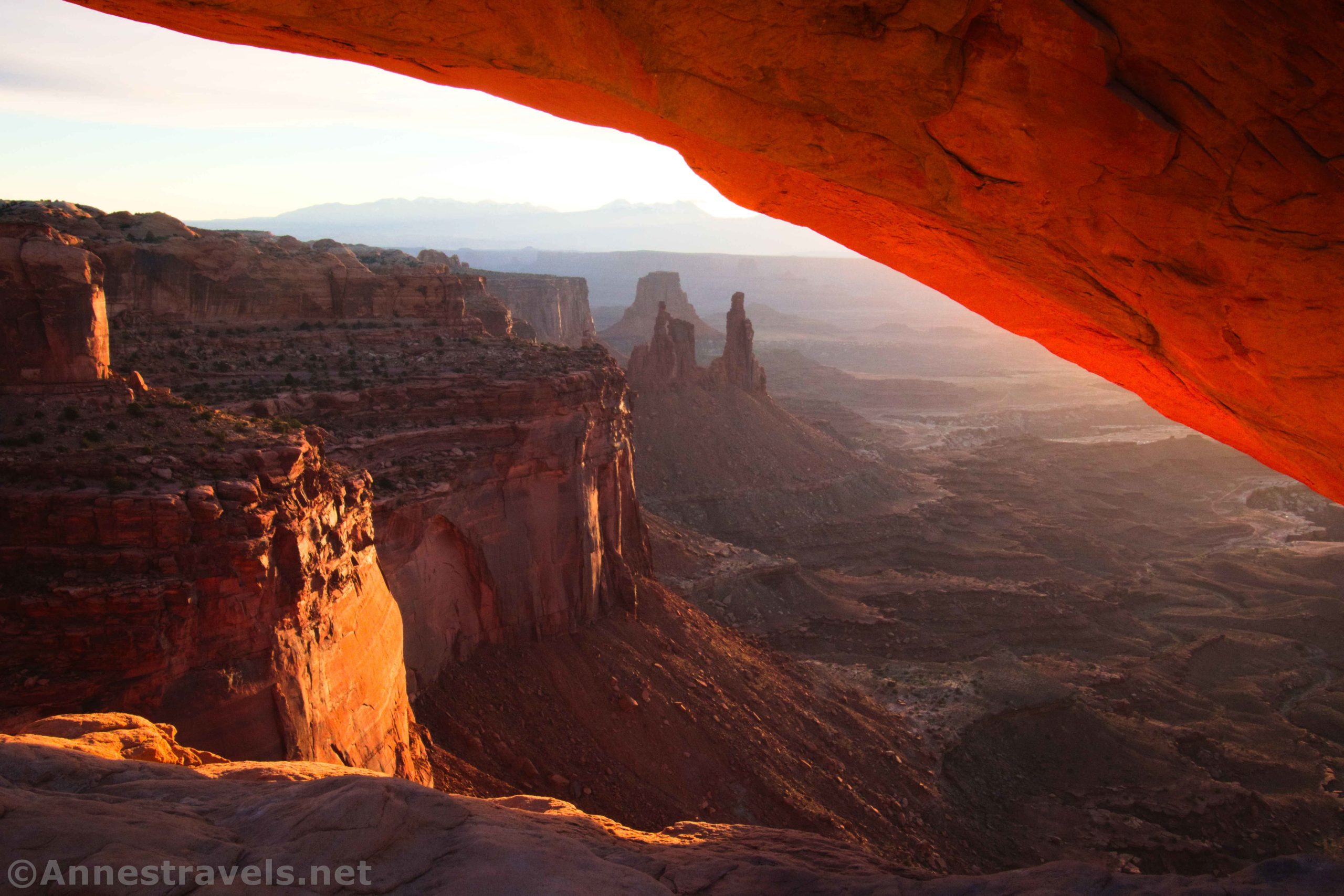 Views of rock formations through Mesa Arch near sunrise, Island in the Sky District, Canyonlands National Park, Utah