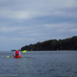 A kayaker on Lake Ontario between Sandbar Park and Webster Park, New York