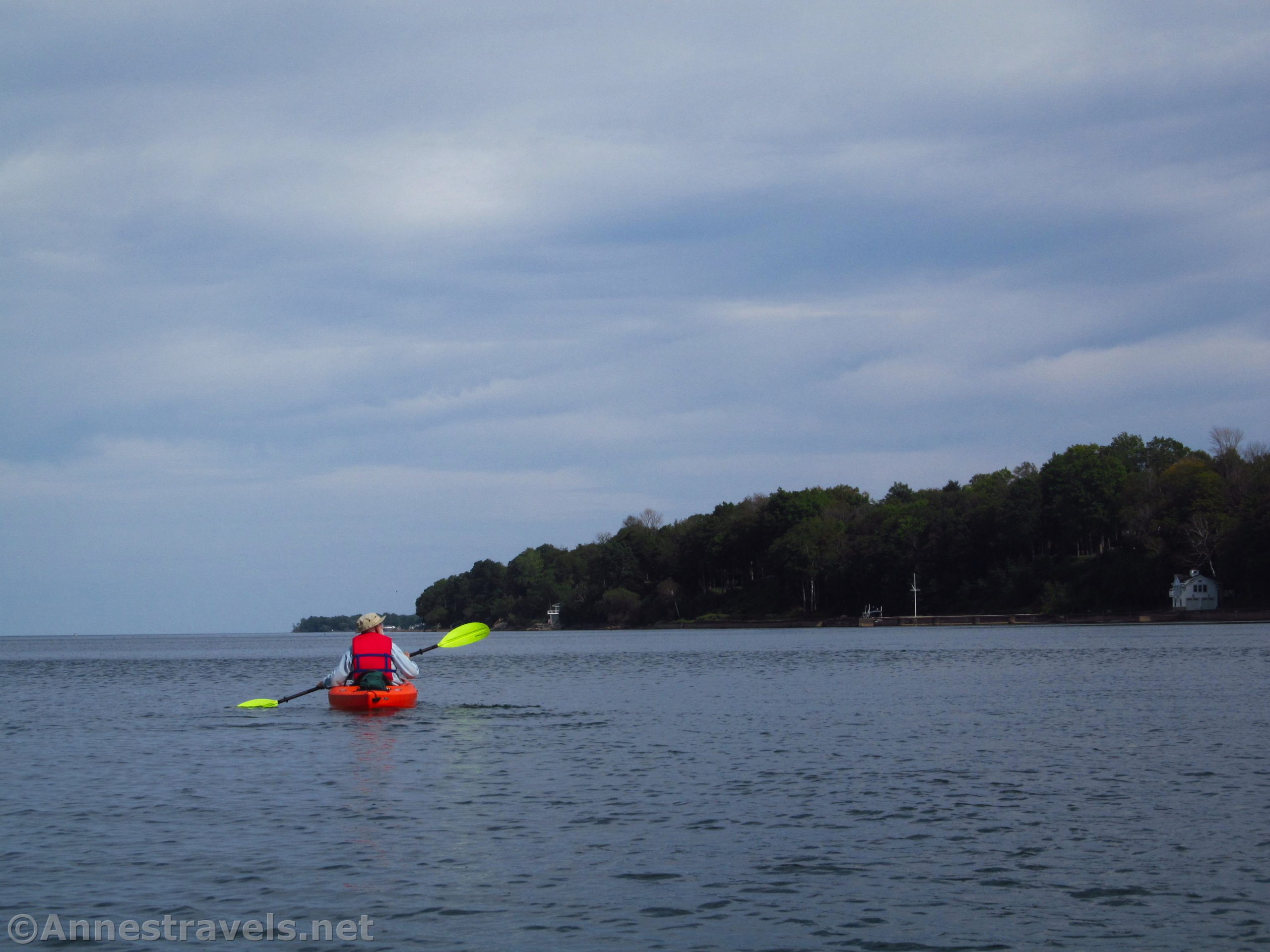 A kayaker on Lake Ontario between Sandbar Park and Webster Park, New York
