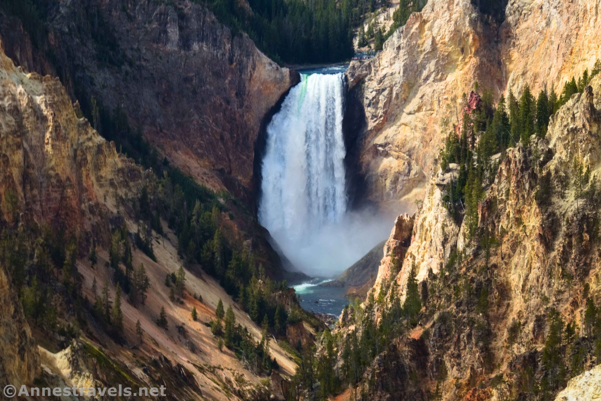 A huge waterfall between yellow cliffs of a canyon