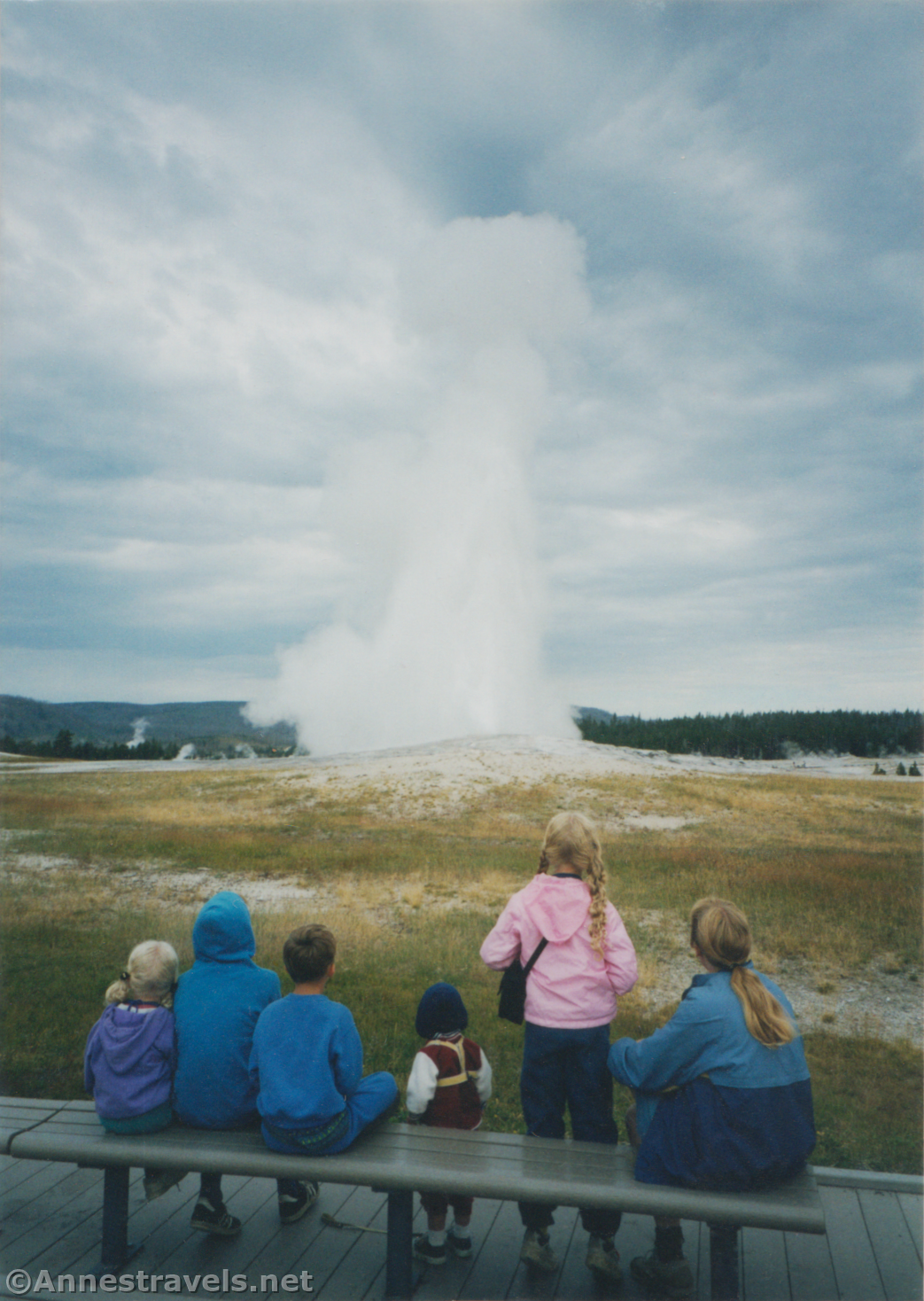 A Family Watching Old Faithful Geyser in 1999, Yellowstone National Park, Wyoming