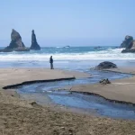 A hiker on China Beach, Samuel H. Boardman State Park, Oregon