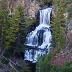 A lovely waterfall between trees and rocks