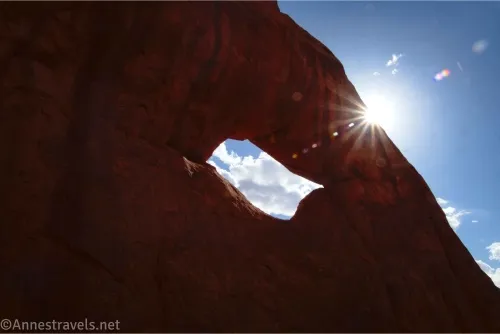 Silhouette of a hole in a rock and a sunstar