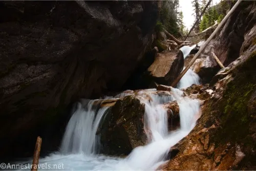 A waterfall tumbles in a gorge over rocks